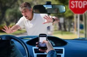 women texting while driving about to hit a pedestrian