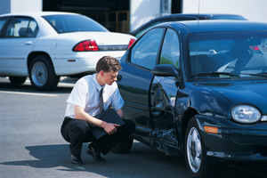 Insurance agent inspecting damage to car