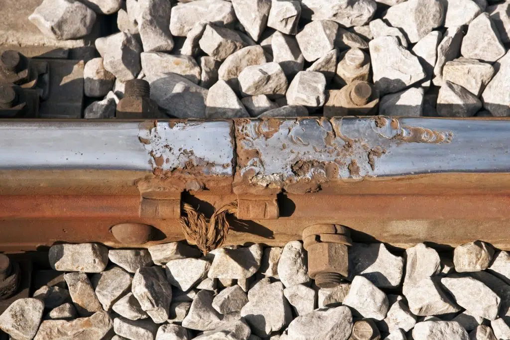 View of damaged metal coating on railroad track