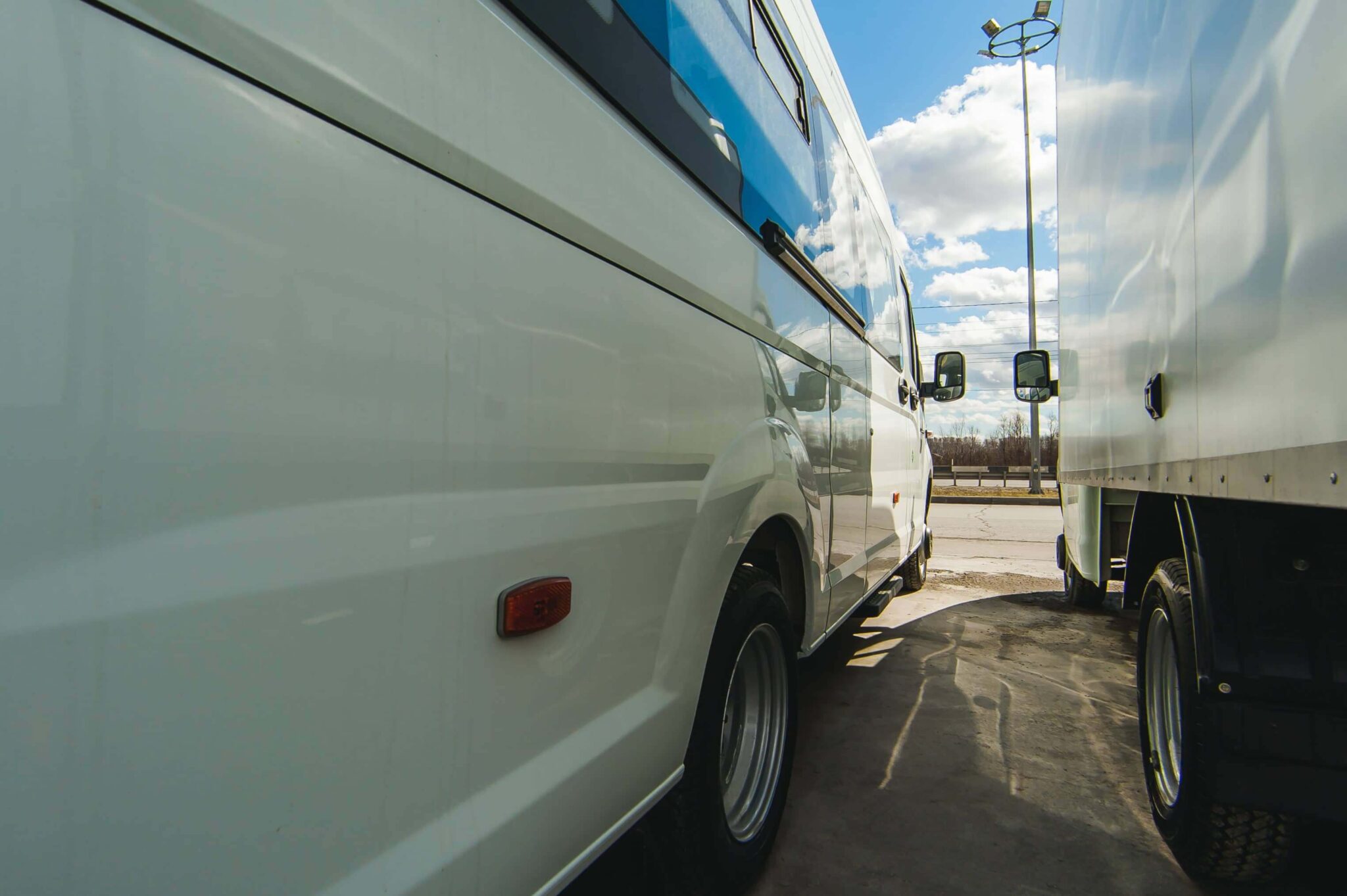 side view of two parked trucks