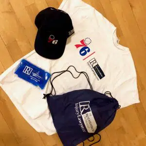 76ers tee-shirt with a hat, ice pack, and gym bag provided by The Rothenberg Law Firm LLP.