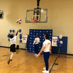 Child shoots a basket at the 76ers safety clinic in Chester, PA.