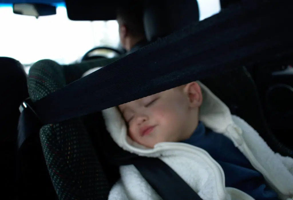 child asleep in rear-facing car seat