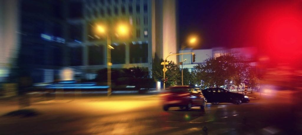 Red car hits a blue one in an intersection.