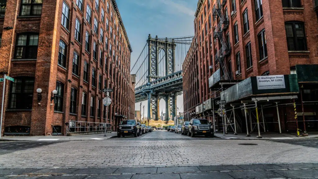 A view of the Manhattan Bridge though a cobblestone street in Brooklyn.