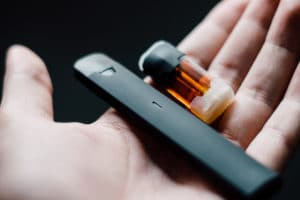 Vape pen with refill pod on hand - Image