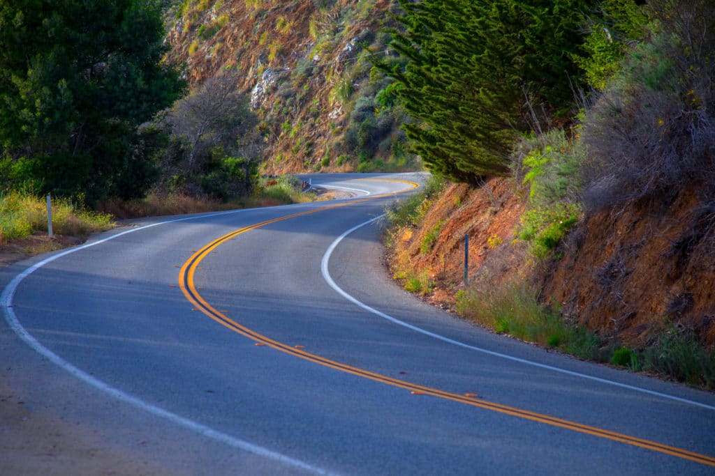 An image of a winding road design in the fall