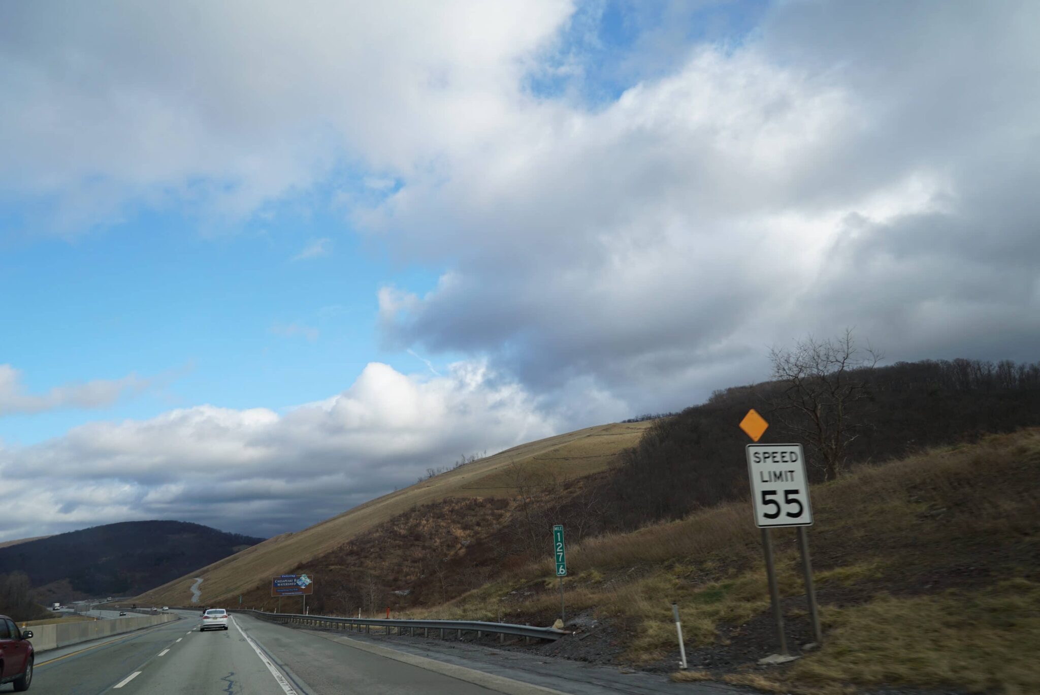 Pennsylvania turnpike on a cloudy day with a 55 miles per hour sign