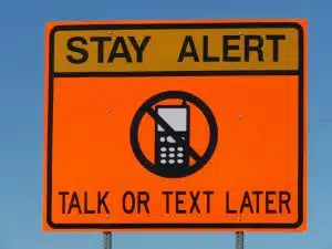 traffic sign: Stay Alert, Talk or Text Later