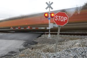 Blurred train moving past a railroad crossing