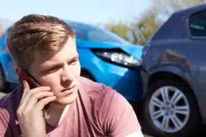 Driver making a phone call after a traffic accident.