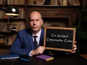 A business idea centered around Car Accident Compensation Claims showcased on a chalkboard with accompanying text.