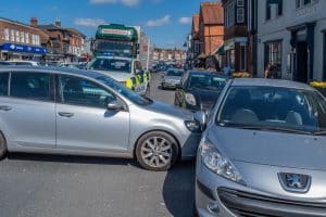 Two cars collides with each other in a T-shape.