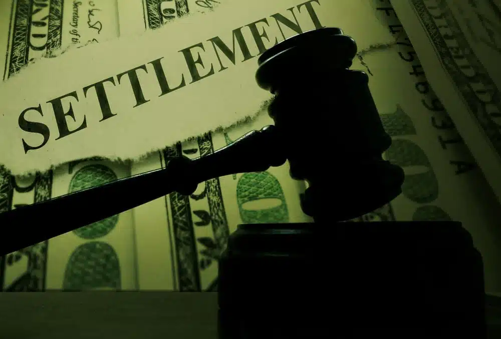 judge legal gavel with cash money and Settlement message