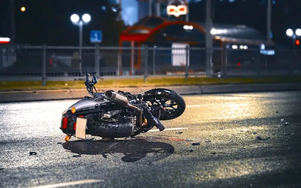 Motorcycle lying on asphalt after a road accident.