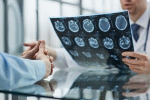 Brain injury after a car accident patient at a reception at the doctor looking an x-ray