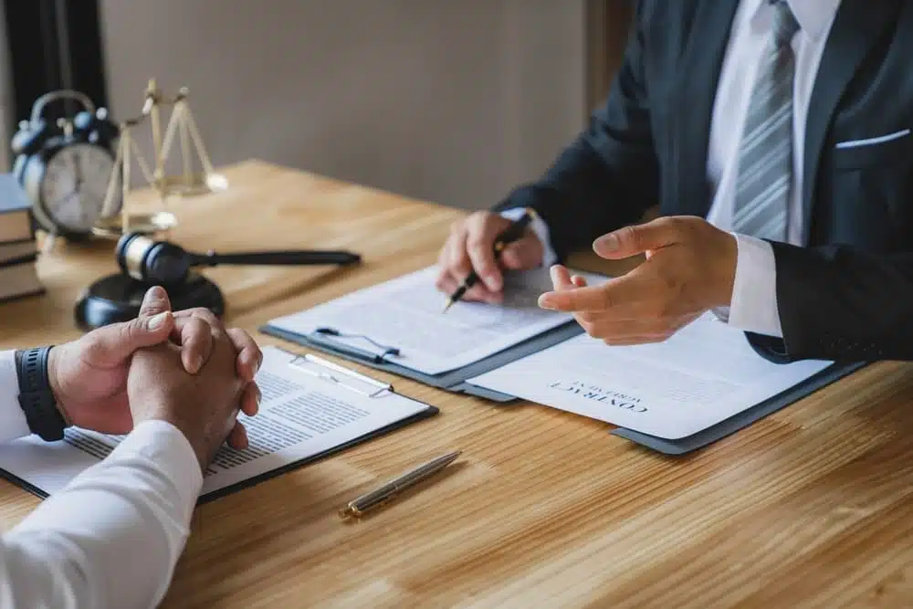 The lawyer working with a client discussing contract paper, a Business lawyer working about legal legislation in the courtroom to help their customer.