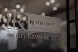 The Rothenberg Law Firm LLP logo on glass