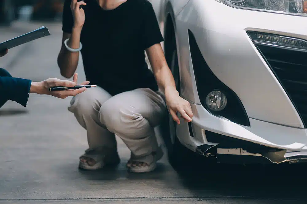 Person reviewing car insurance options at a desk, symbolizing the complex insurance coverage after a Lyft accident near Philadelphia International Airport.